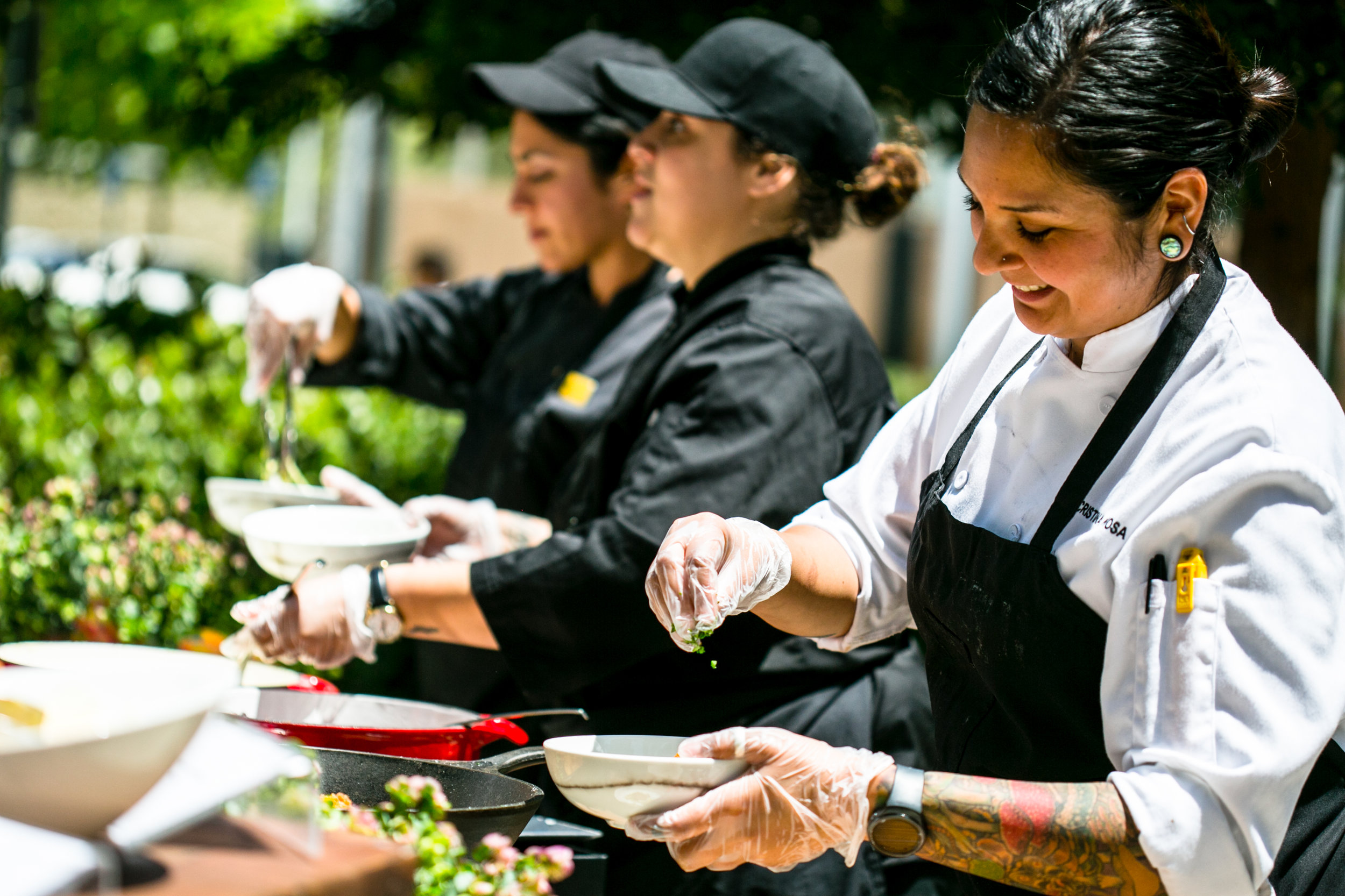 Catering staff from a facilities management company serving food outdoors